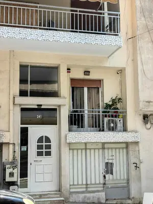 a building with a white door and a balcony at Funky Boho Kallithea Loft in Athens