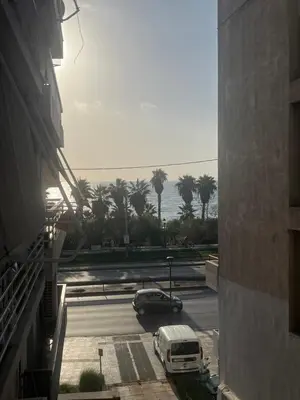 a car parked in a parking lot next to a building at The Cosy luxurious Seaside Apartment in Athens