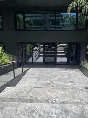 an entrance to a building with glass doors at The Cosy luxurious Seaside Apartment in Athens