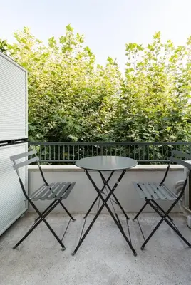 a table and two chairs on a balcony at Frinichou 18 by Athens Concept Residences in Athens