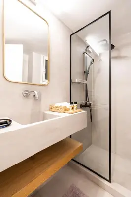 a bathroom with a sink and a shower at Frinichou 18 by Athens Concept Residences in Athens