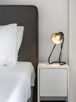a lamp on a night stand next to a bed at Relux Sea View 2 Bedroom Apartment by BluPine in Athens