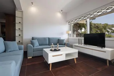 a living room with a couch and a tv at Relux Sea View 2 Bedroom Apartment by BluPine in Athens