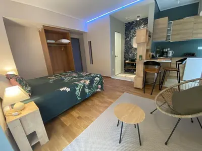 a bedroom with a bed and a living room and a kitchen at Studio for a couple in Athens