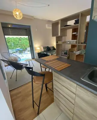 a kitchen with a counter and a table and chairs at Studio for a couple in Athens