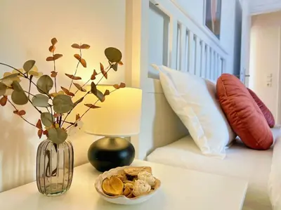 a table with a vase and a bowl of food on it at Cozy fairytal garden apartment, Family Friendly, Free parking, 15 Min to Airport in Athens