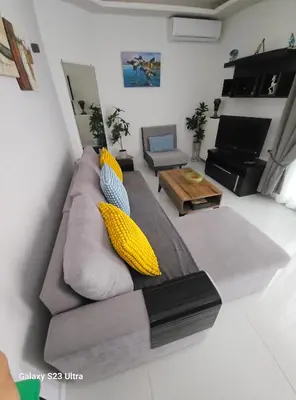 a living room with a gray couch with yellow pillows at Keti's home in Athens