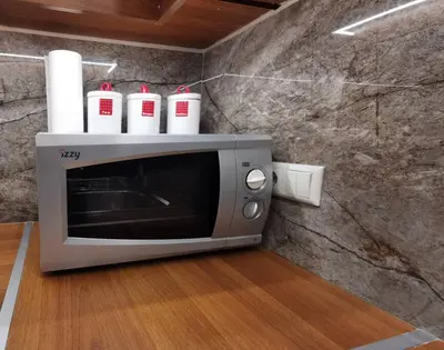 a microwave with four cups on top of it at Keti's home in Athens