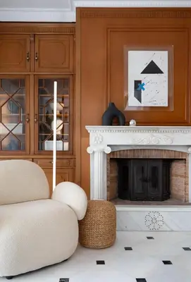 a living room with a fireplace and a chair at The Southern Mansion Athens in Athens