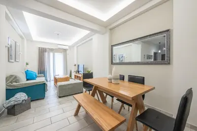 a living room with a wooden table and a mirror at Supreme Athens Home by Cloudkeys in Athens