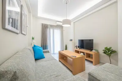 a living room with a couch and a tv at Supreme Athens Home by Cloudkeys in Athens
