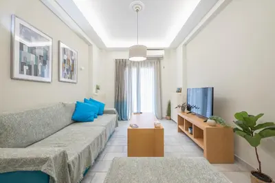 a living room with a couch and a tv at Supreme Athens Home by Cloudkeys in Athens