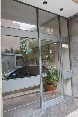 a window of a store with a car in it at Supreme Athens Home by Cloudkeys in Athens