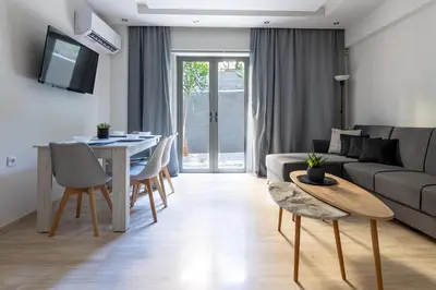 a living room with a couch and a table at Greyt Apartments Glyfada in Athens