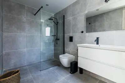 a bathroom with a shower and a toilet and a sink at Greyt Apartments Glyfada in Athens