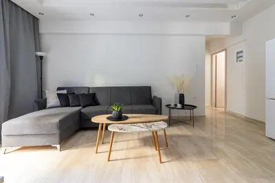 a living room with a couch and a table at Greyt Apartments Glyfada in Athens