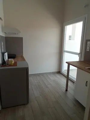 a kitchen with a counter and a table in a room at Elia Apartments in Agia Marina Aegina