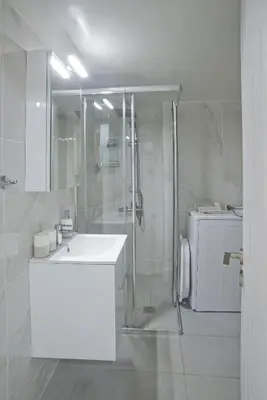 a white bathroom with a shower and a sink at Sofia's Home Piraeus Modern, Reno, Fully Equipped in Piraeus