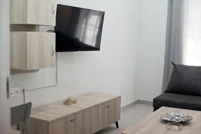 a living room with a coffee table and a flat screen tv at Sofia's Home Piraeus Modern, Reno, Fully Equipped in Piraeus