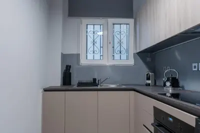 a kitchen with a sink and a window at Athens Oasis - Timeless comfort at the Acropolis in Athens