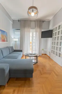 a living room with a couch and a table at Athens Oasis - Timeless comfort at the Acropolis in Athens