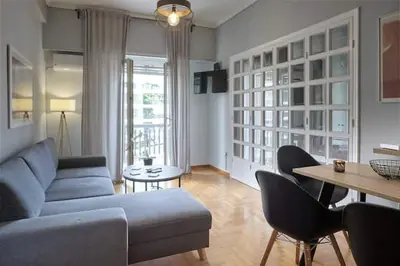 a living room with a couch and a table at Athens Oasis - Timeless comfort at the Acropolis in Athens