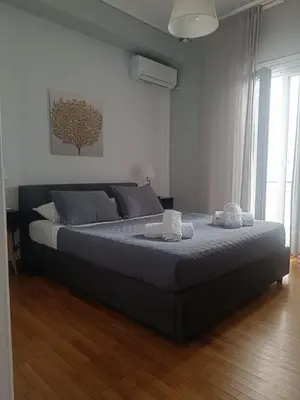 a bedroom with a bed with two towels on it at Athens Oasis - Timeless comfort at the Acropolis in Athens