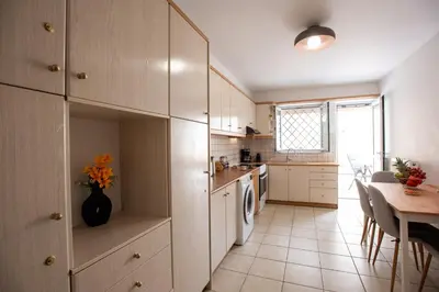 a kitchen with a table and a dining room at KG Acropolis Escape Spa Apartment in Athens