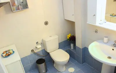 a bathroom with a toilet and a sink at KG Acropolis Escape Spa Apartment in Athens