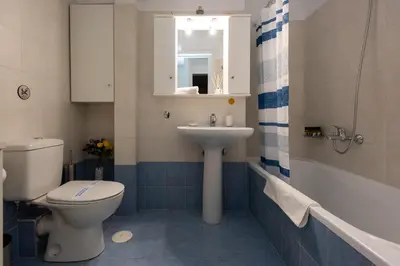 a bathroom with a toilet and a sink at KG Acropolis Escape Spa Apartment in Athens