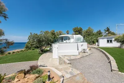 a white house with a view of the ocean at Villa Tholos -Athens Riviera in Kalívia Thorikoú