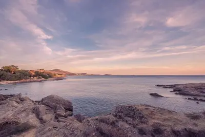a view of a body of water with rocks at Villa Tholos -Athens Riviera in Kalívia Thorikoú