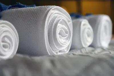 a row of white rolls of wrapping paper on a bed at House in riviera lagonisi in Kalívia Thorikoú