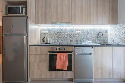 a kitchen with a refrigerator and a stove top oven at Athens Gem in Koukaki in Athens