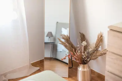 a vase with a plant in it next to a mirror at Athens Gem in Koukaki in Athens