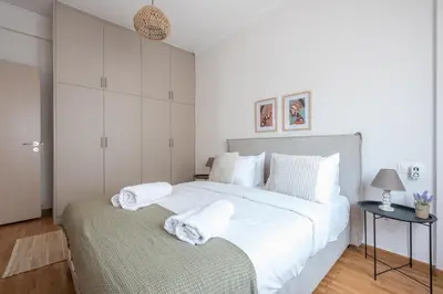 a bedroom with a large white bed with towels on it at Athens Gem in Koukaki in Athens