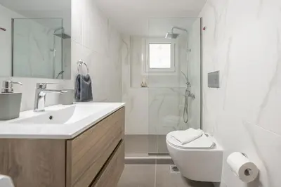 a bathroom with a sink and a toilet and a shower at Athens Gem in Koukaki in Athens