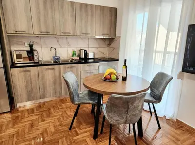 a kitchen with a table with a bowl of fruit on it at Attiki Rooftop Apartment VIPGreece in Athens