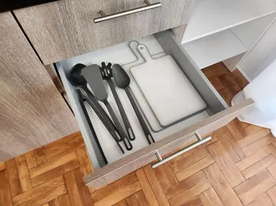 an open drawer with utensils in a kitchen at Attiki Rooftop Apartment VIPGreece in Athens