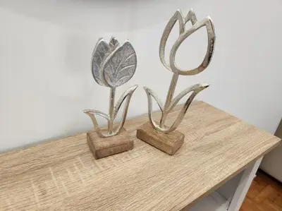 two metal flowers on top of a wooden table at Attiki Rooftop Apartment VIPGreece in Athens