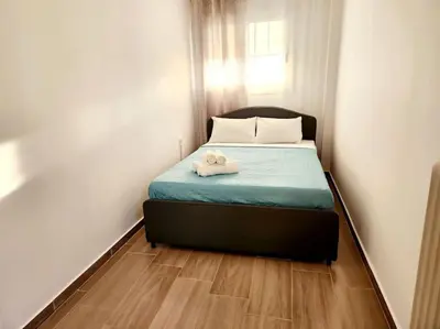 a small bedroom with a bed with two stuffed animals on it at Attiki Rooftop Apartment VIPGreece in Athens