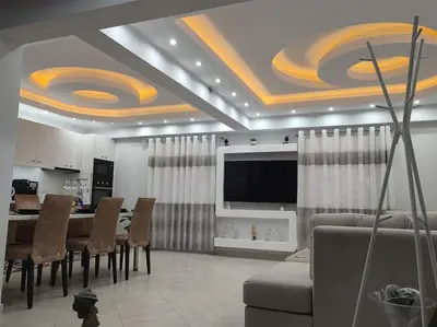 a living room with a dining table and a television at Apartment in the Center of Athens in Athens