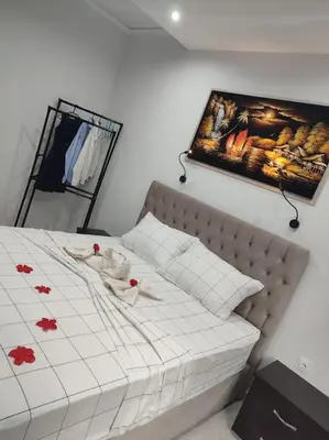 a bedroom with a bed and a picture on the wall at Apartment in the Center of Athens in Athens