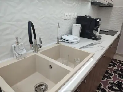 a kitchen counter with a sink and a coffee maker at Apartment in the Center of Athens in Athens