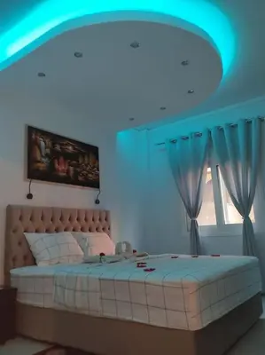 a bedroom with a large bed with a blue ceiling at Apartment in the Center of Athens in Athens