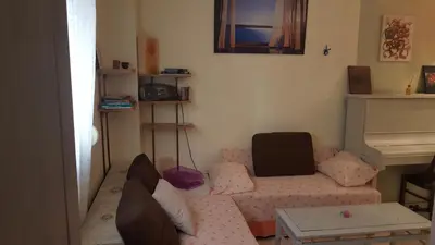 a living room with a couch and a table at Comfy home 35sqm near National Garden in Athens