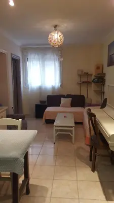 a living room with a couch and a table at Comfy home 35sqm near National Garden in Athens