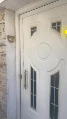 a white door with two windows on a house at Comfy home 35sqm near National Garden in Athens