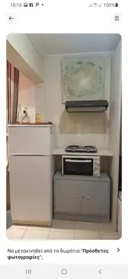 a kitchen with a stove and some white cabinets at Comfy home 35sqm near National Garden in Athens