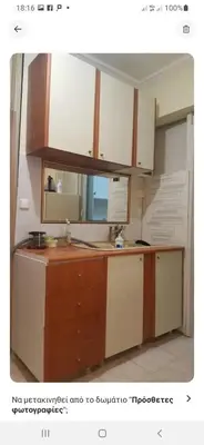 a kitchen with white cabinets and wooden counters at Comfy home 35sqm near National Garden in Athens